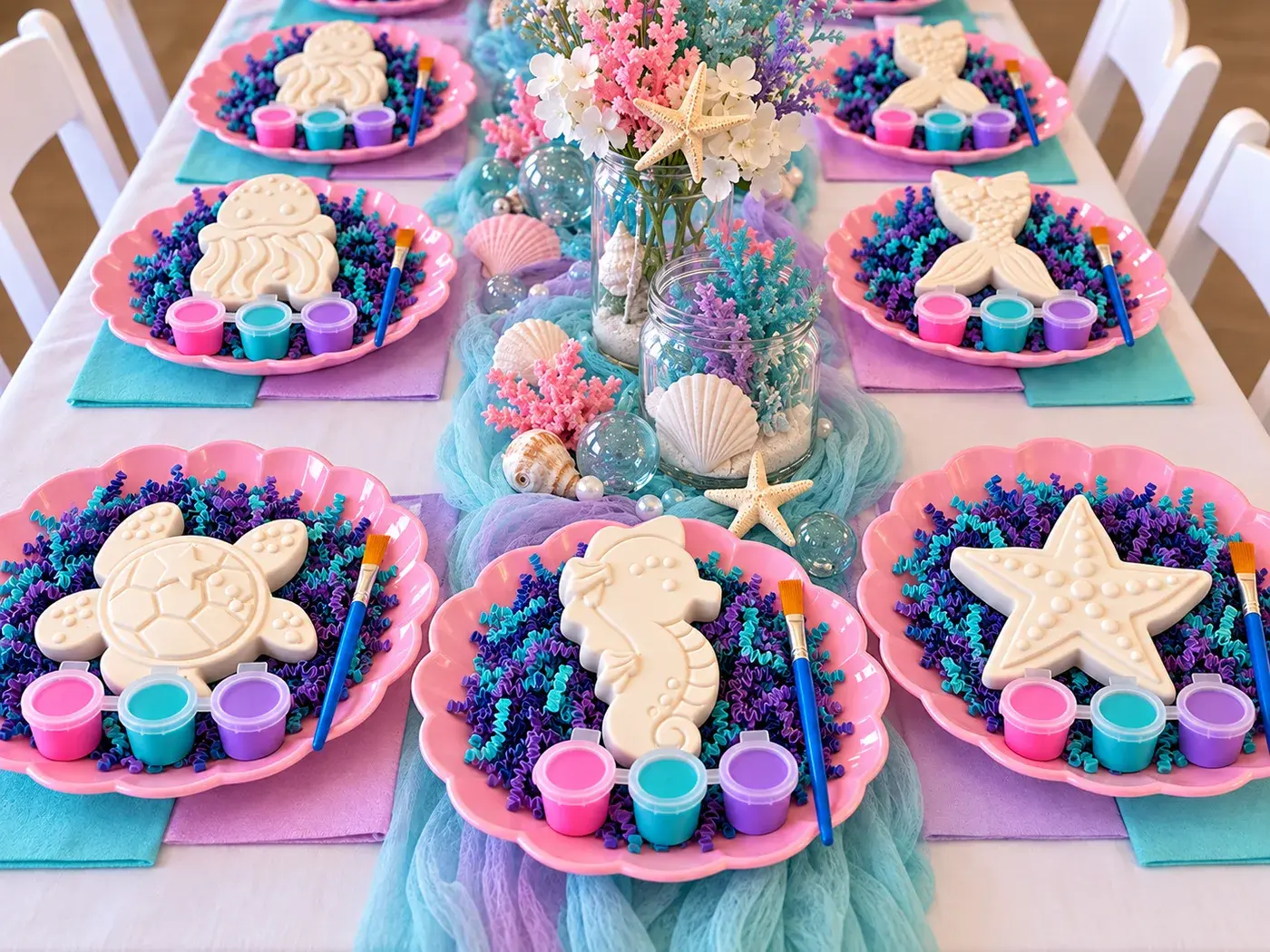 Under the Sea kit set up on a party table, one figurine and paint set per guest