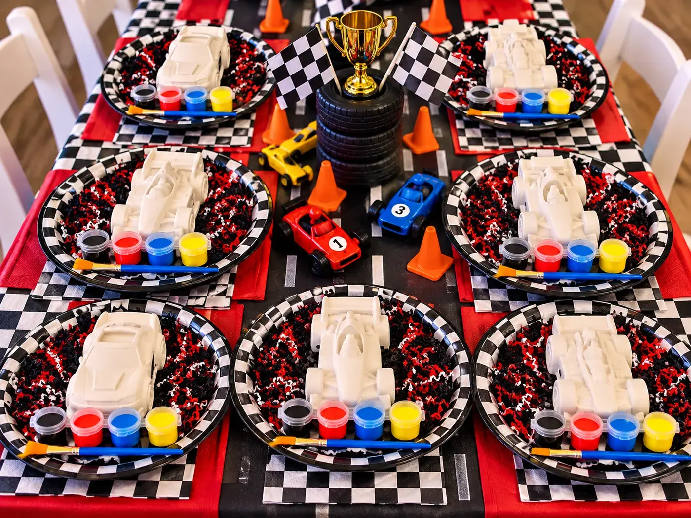 Race Day kit set up on a party table, one figurine and paint set per guest